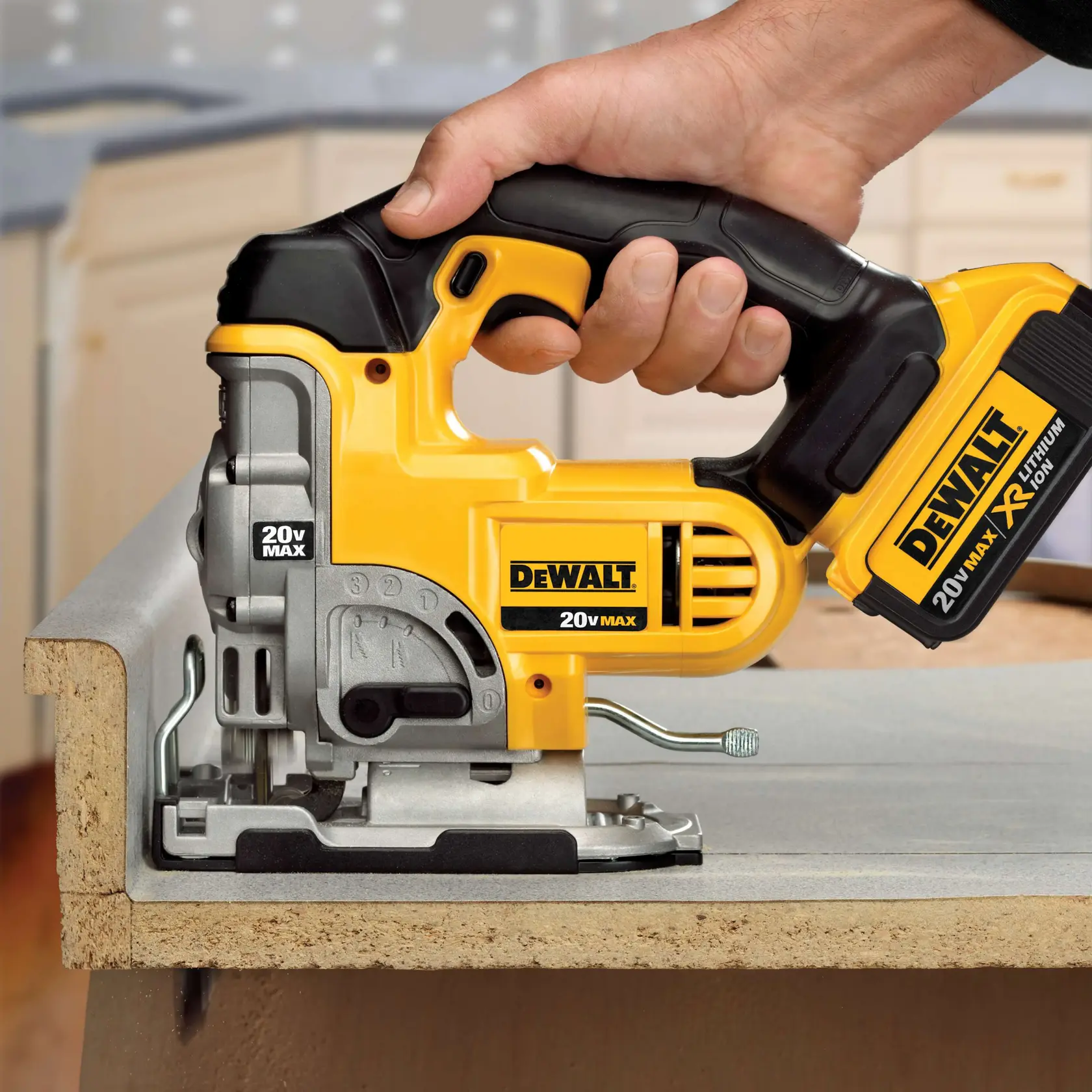 Primer plano de una persona usando una sierra de calar inalámbrica DEWALT 20V MAX para cortar una pieza de madera en un taller o cocina.